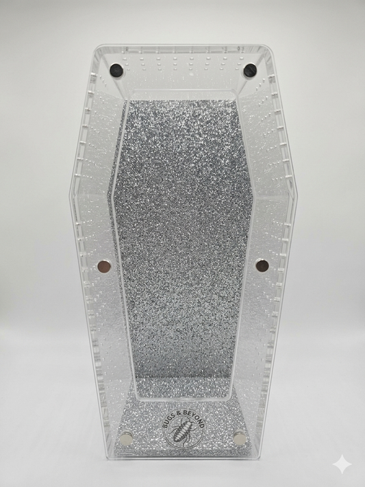 Clear glittery coffin-shaped Enclosure with 'Bugs & Beyond' Logo on a white background