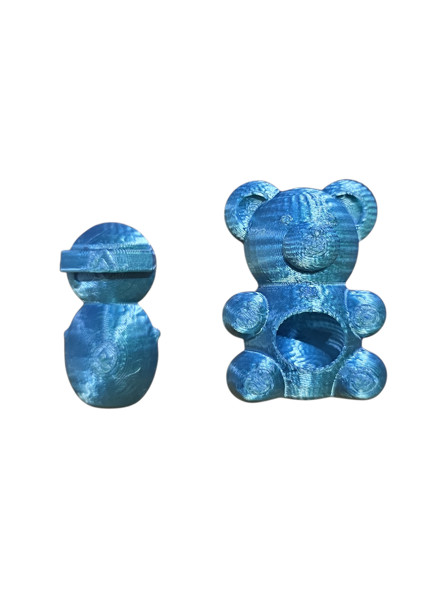 A jumping spider hide in the shape of a blue teddy bear showing the back magnetic part on a white background