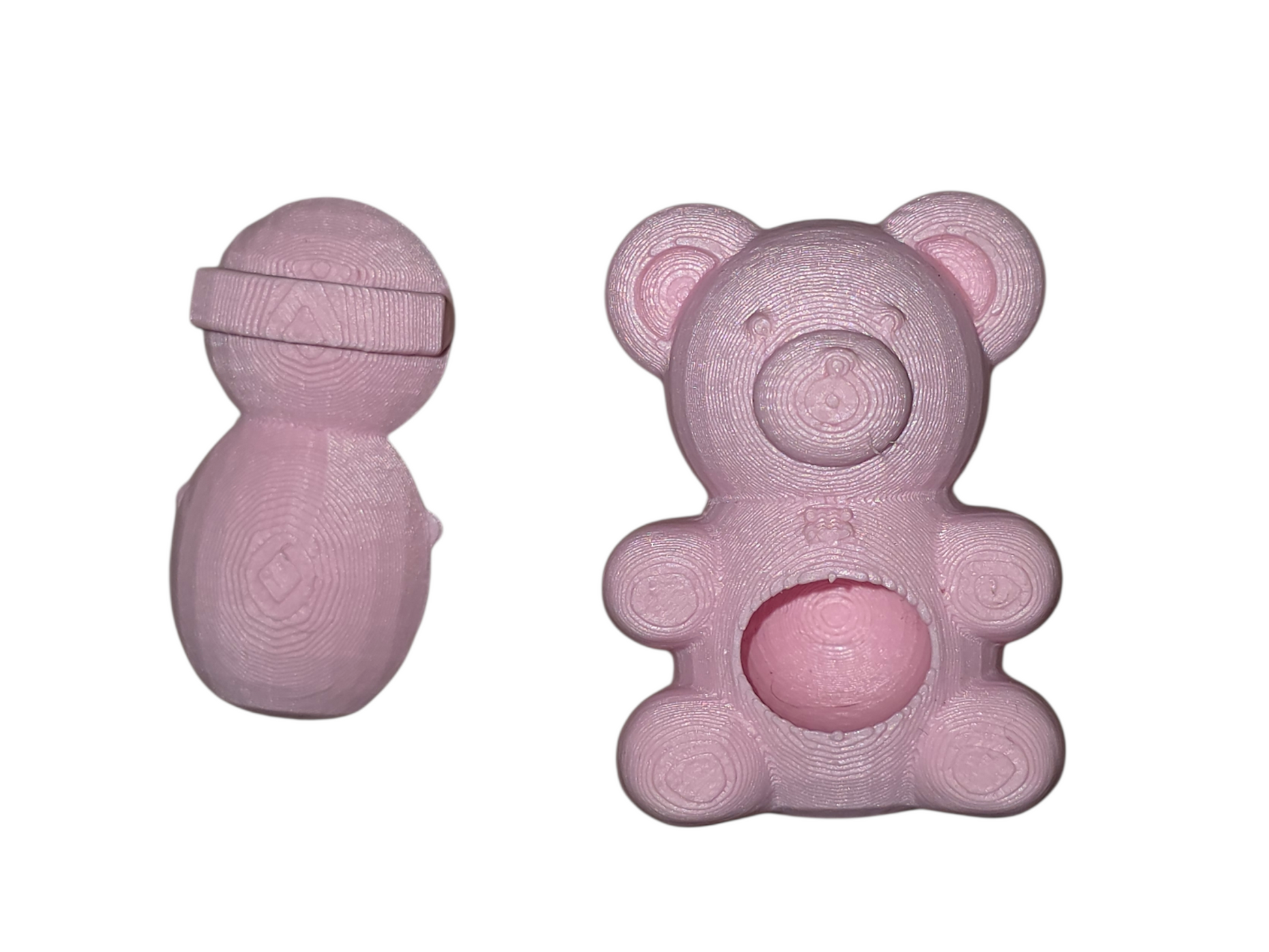 A jumping spider hide in the shape of a pink teddy bear showing the back magnetic part on a white background